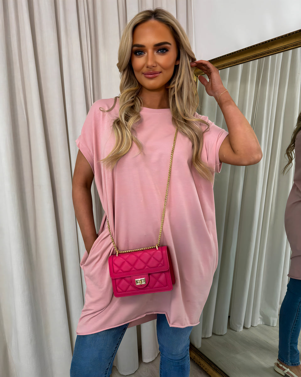 Pink oversized round-neck top with side pockets and short sleeves