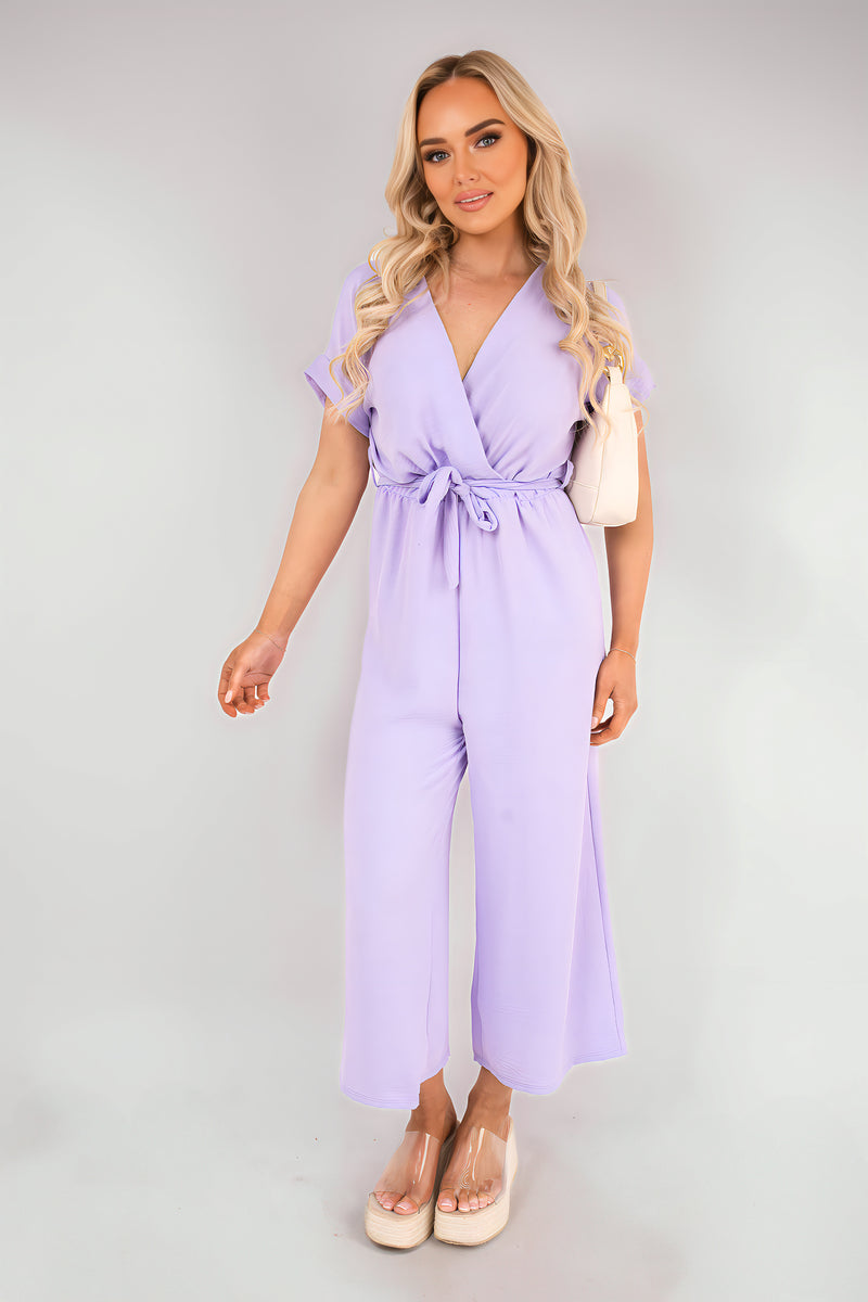 Lilac wrap short-sleeve wide-leg jumpsuit with tie waist, full length front view.
