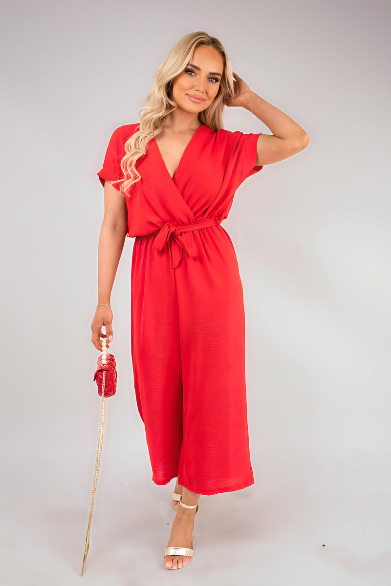 Red wrap V-neck jumpsuit with tie waist, short sleeves and wide-leg pants