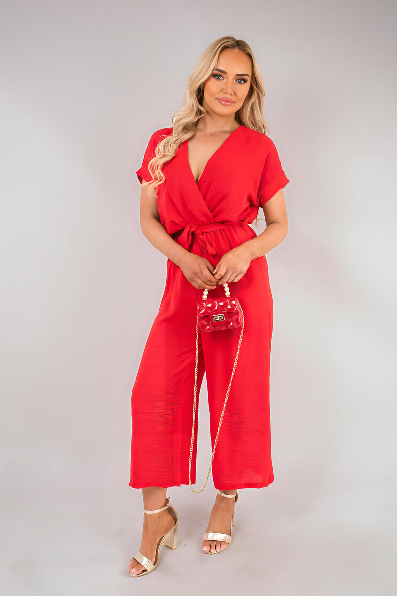 Red wrap jumpsuit with short sleeves and tie waist, wide cropped legs