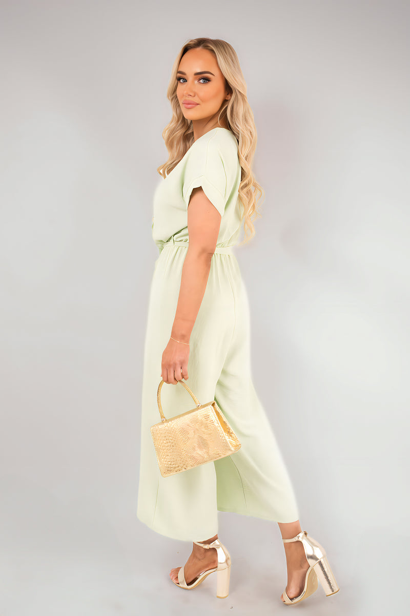 Pale green wrap V-neck jumpsuit with tie waist, short sleeves and wide-leg hem