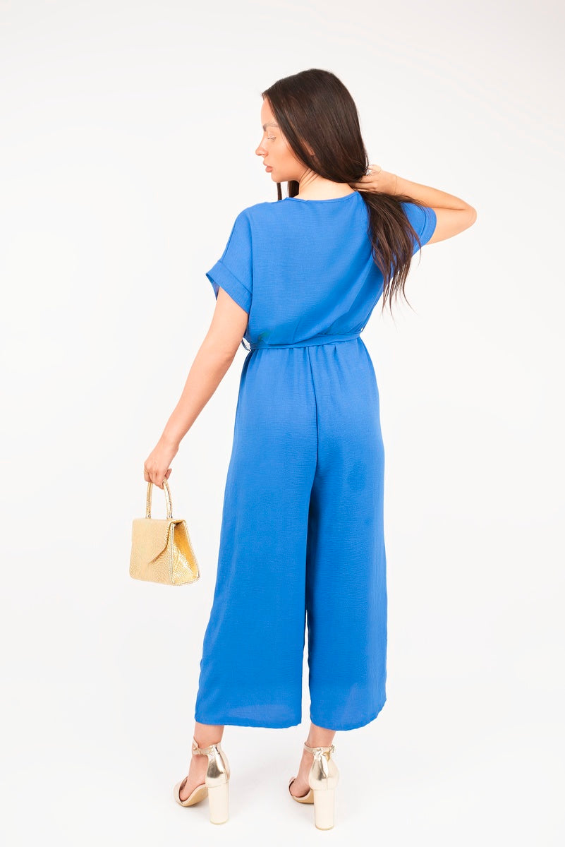 Blue wrap tie-waist jumpsuit with short sleeves and wide legs, back view