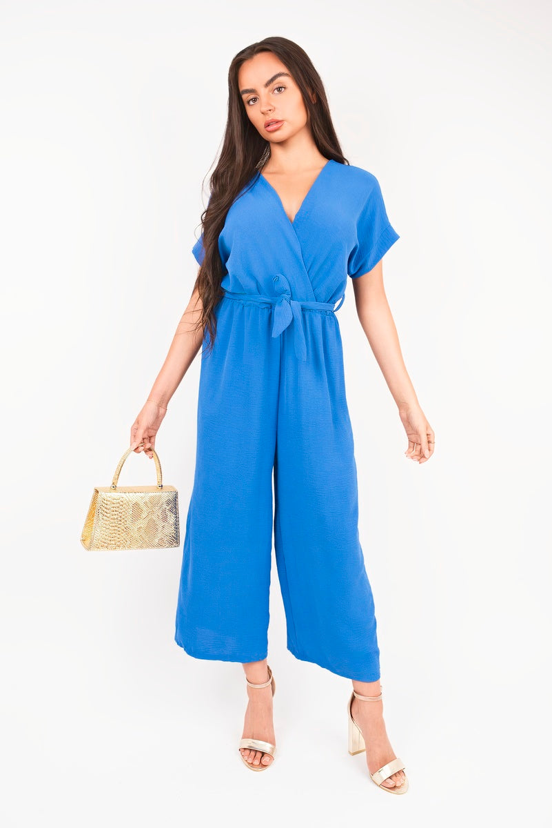 Blue wrap V-neck jumpsuit with short sleeves, tie waist and wide straight legs