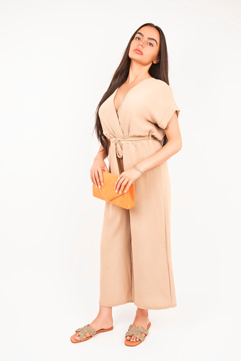 Beige wrap short-sleeve wide-leg jumpsuit with tie waist, front view.