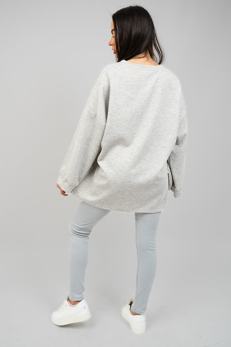 Oversized long-sleeve sweatshirt top, light grey, back view with relaxed sleeves.