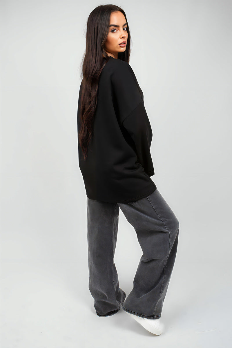 Black oversized long-sleeve sweatshirt shown in side profile
