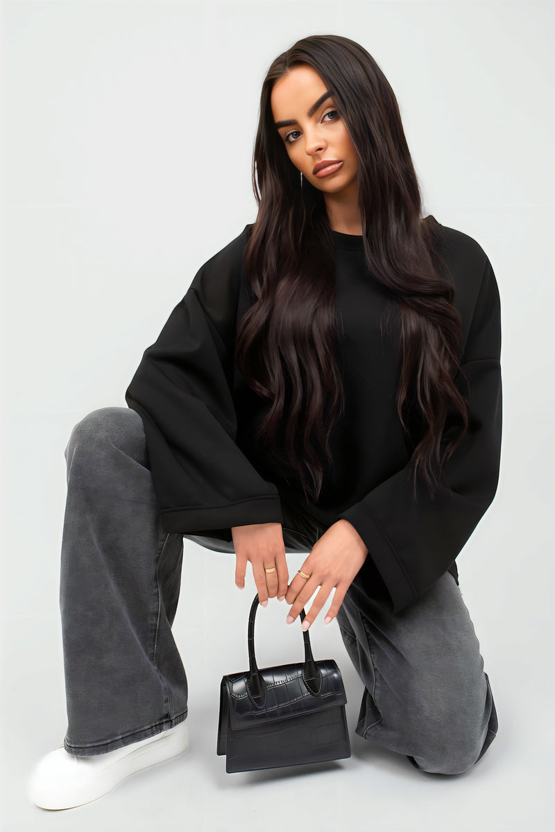 Black oversized long-sleeve sweatshirt with relaxed drape and round neck