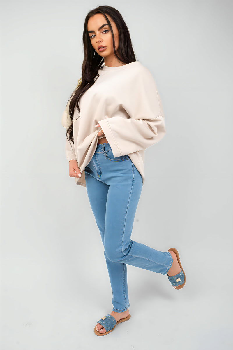 Cream oversized long-sleeve sweatshirt with dropped shoulders and cuffs