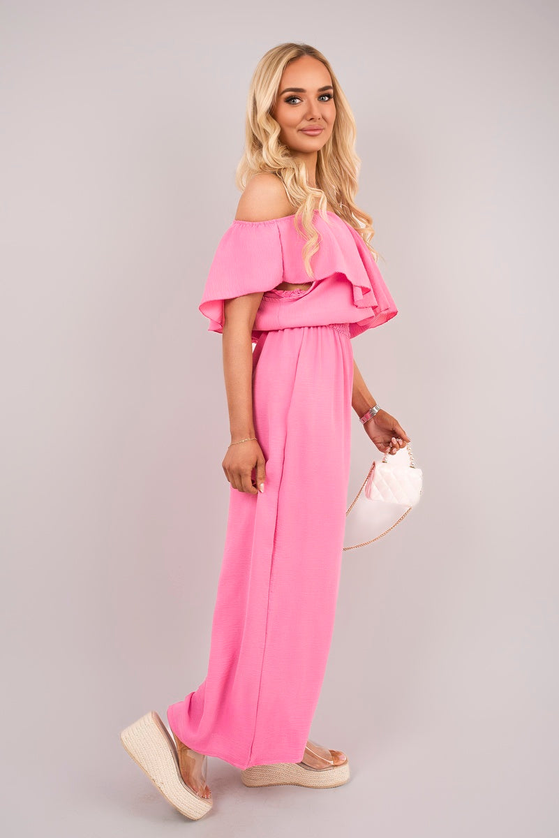 Pink off-shoulder ruffle jumpsuit with layered neckline and wide-leg pants