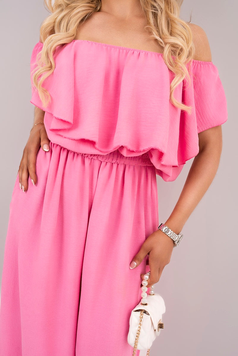 Pink off-shoulder ruffle jumpsuit bodice close-up with smocked waist and layered ruffles
