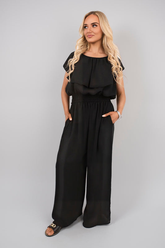 Black off-shoulder ruffle jumpsuit with wide-leg pants and gathered waist