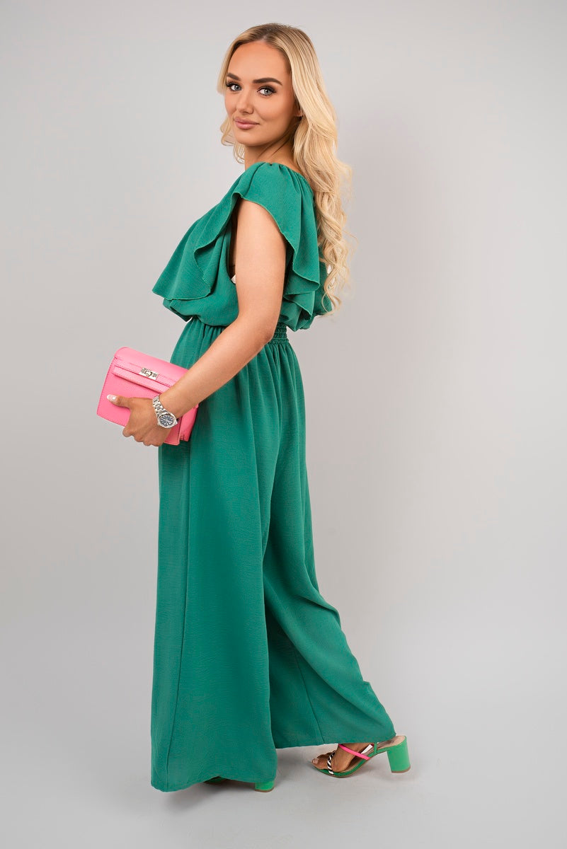 Green off-shoulder wide-leg jumpsuit with tiered ruffle sleeves and gathered waist