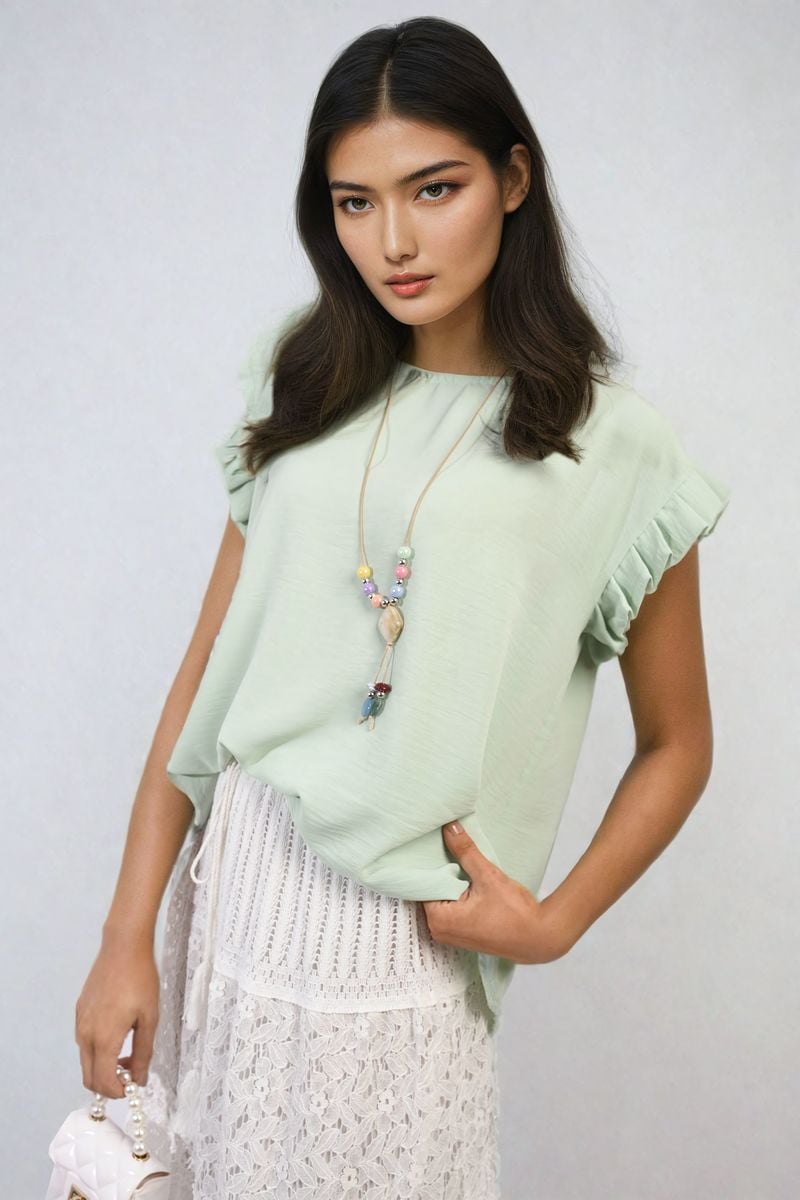Mint green ruffle-trim sleeve top with round neckline and draped sleeve ruffles