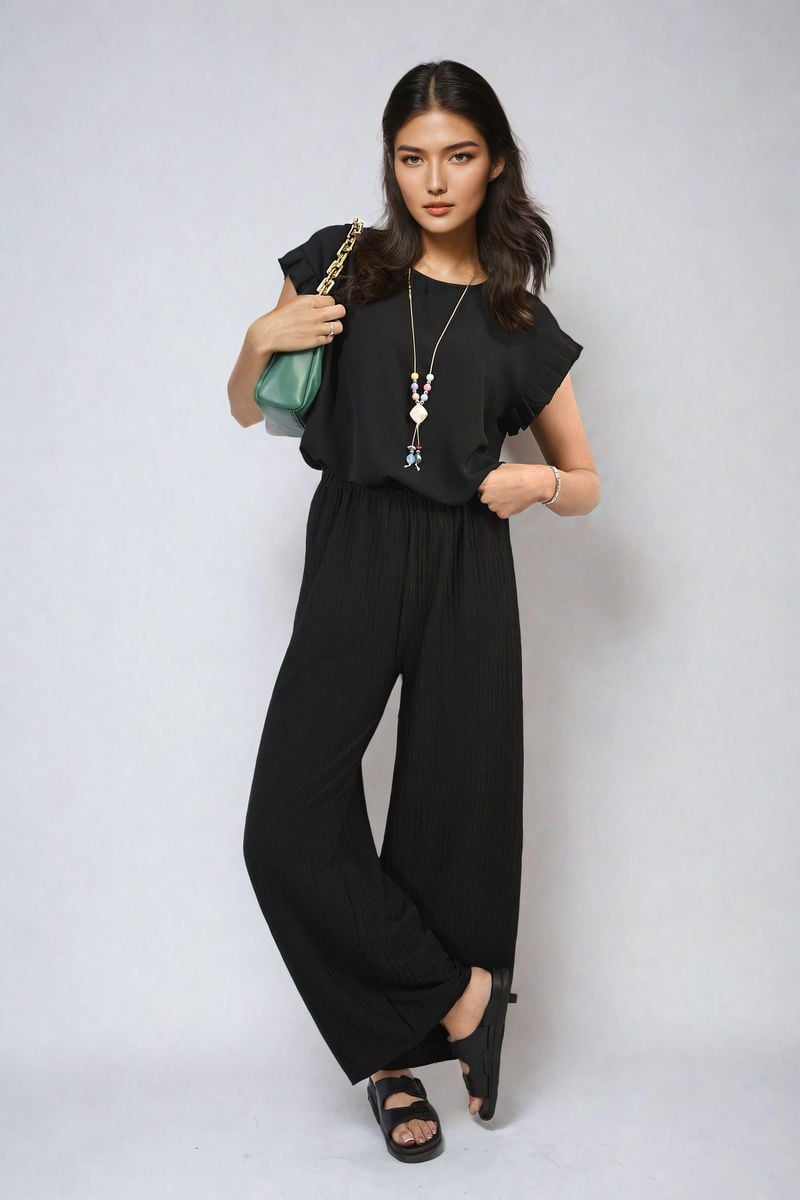 Ruffle trim sleeve top in black with ruffled short sleeves and crew neckline
