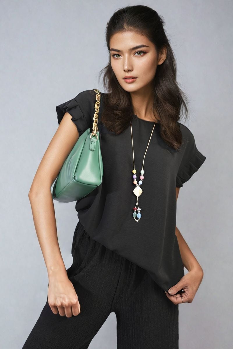 Ruffle trim sleeve top in black with ruffled short sleeves and crew neckline