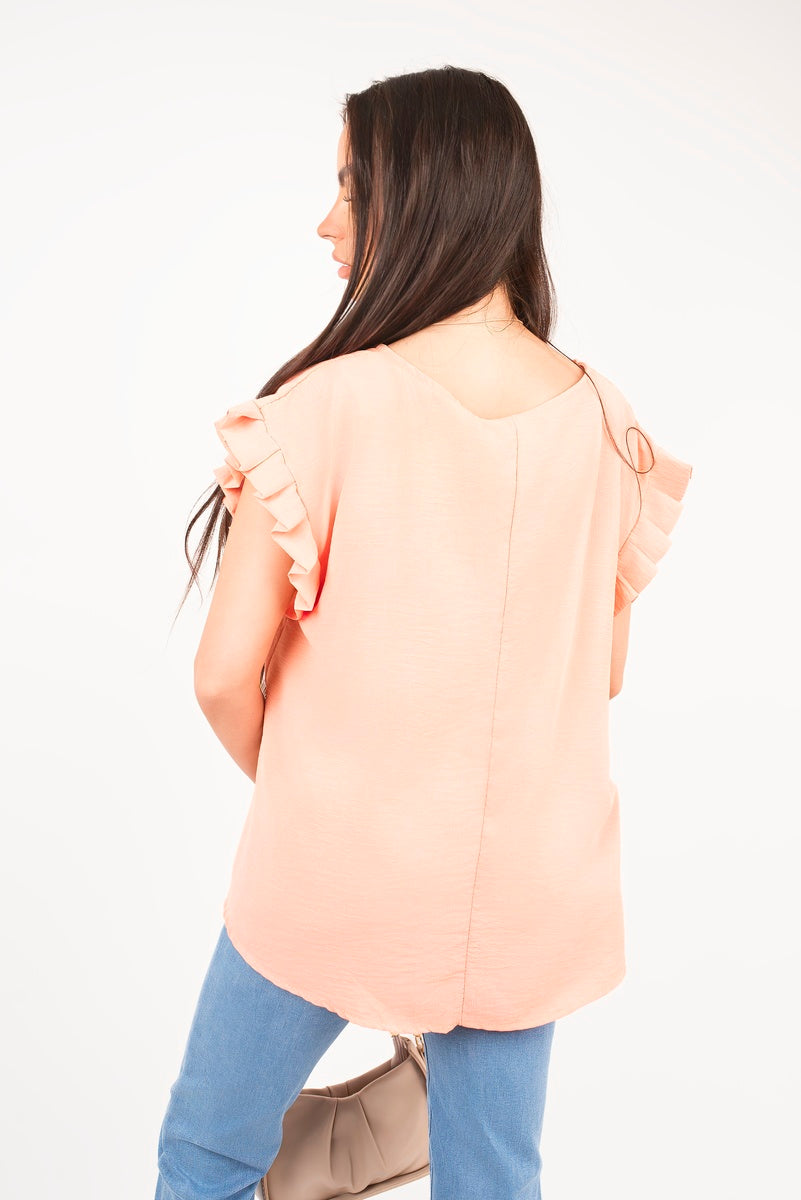 Light pink ruffle-trim sleeve top, back view with flutter ties at sleeves
