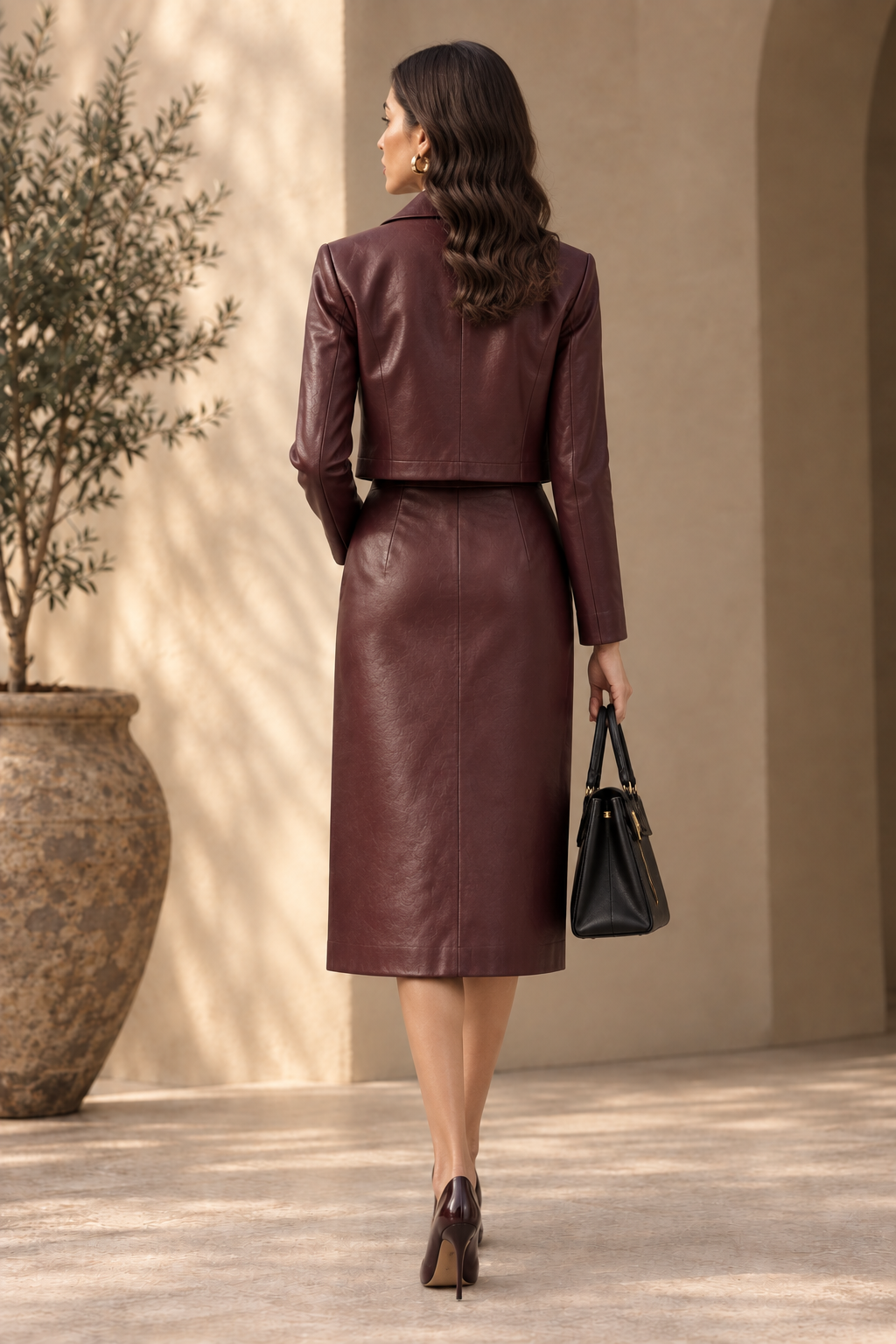 Burgundy cropped leather jacket and A-line midi skirt, rear angle