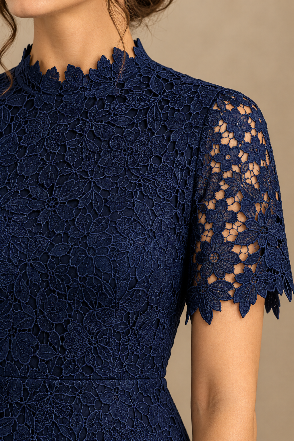 Close-up of the navy floral lace embroidery, high scalloped neckline and short scalloped sleeve detail.