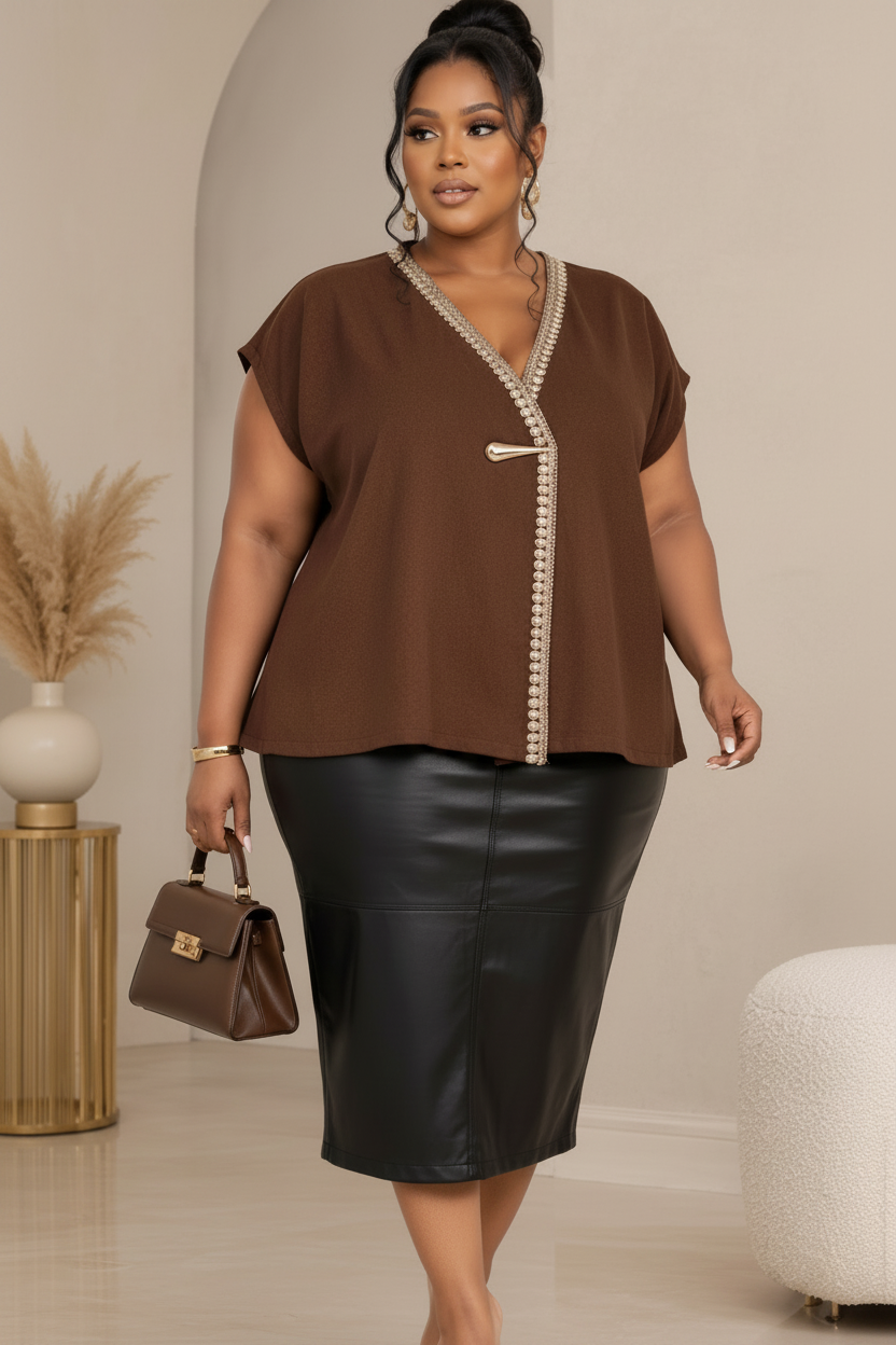 Straight front view of a chocolate-brown embellished blouse styled with a black leather midi skirt