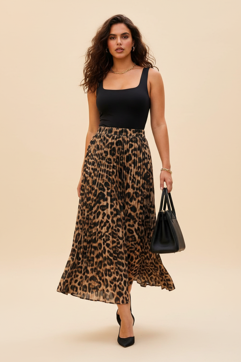 Tall mixed-race model wearing a leopard print pleated midi skirt with elegant accessories